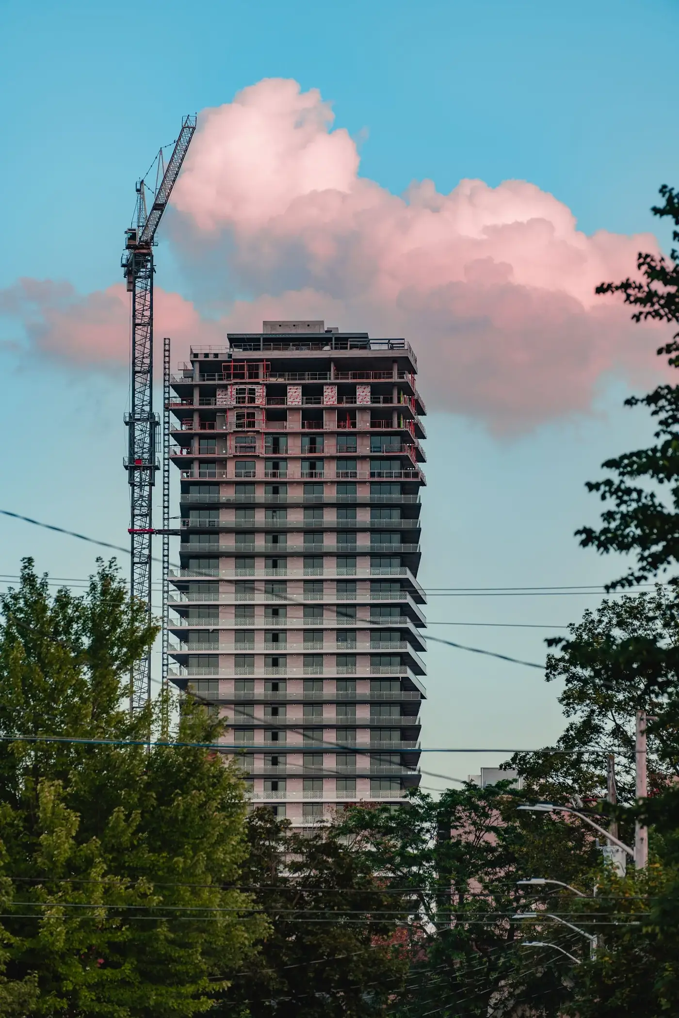 Condominium tower under construction with a tower crane