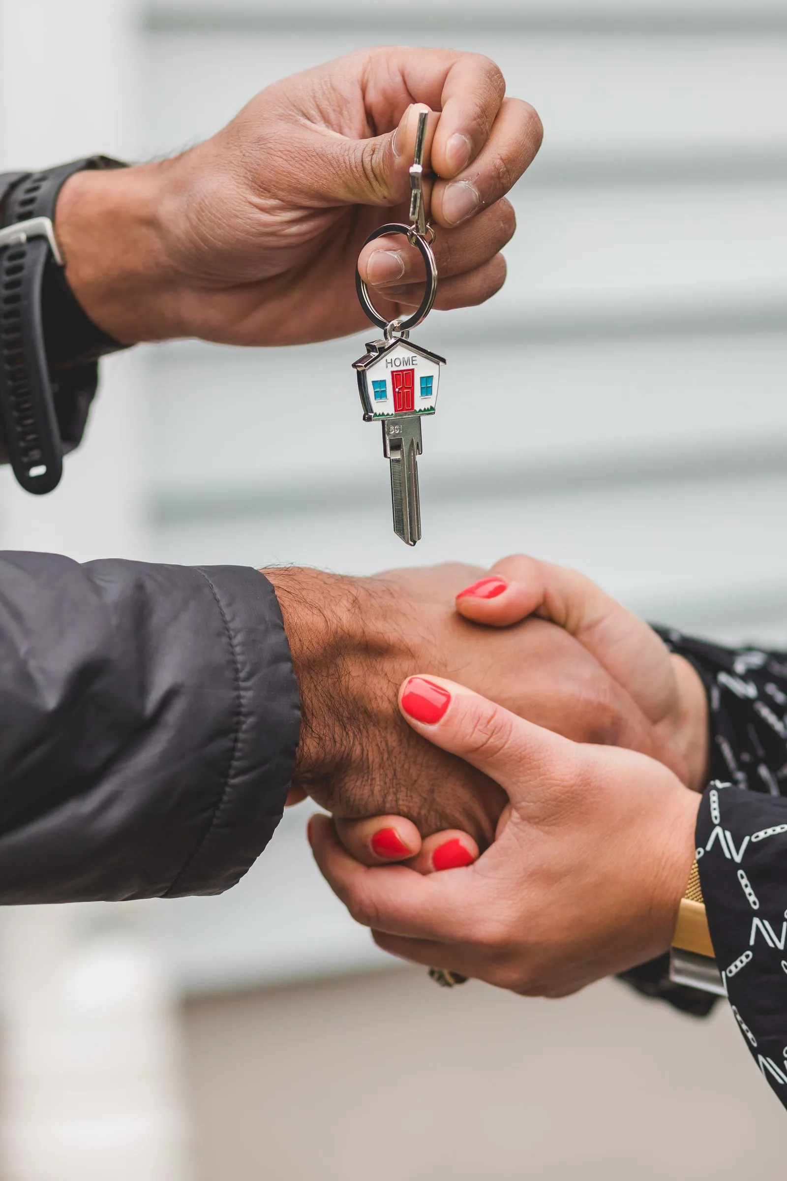 Real estate professional handing over a house key